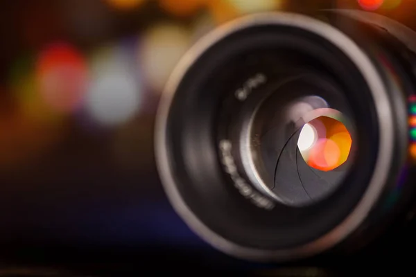 Professional camera lens with reflections.