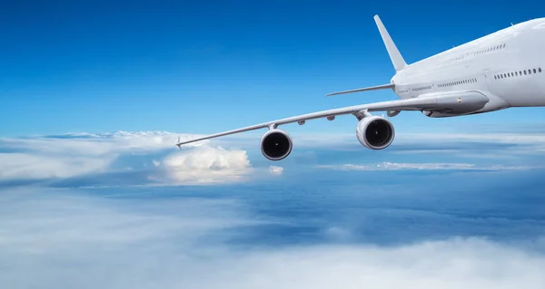 Huge two-storey passengers commercial airplane flying above dramatic clouds. — Stock Photo, Image