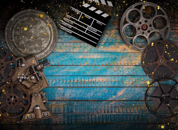Cinema concept of vintage film reels, clapperboard and projector. — Stock Photo, Image