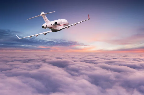 Small private jetplane flying above beautiful clouds. — Stock Photo, Image