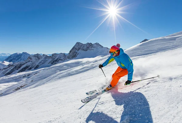 Skier skiing downhill in high mountains — Stock Photo, Image