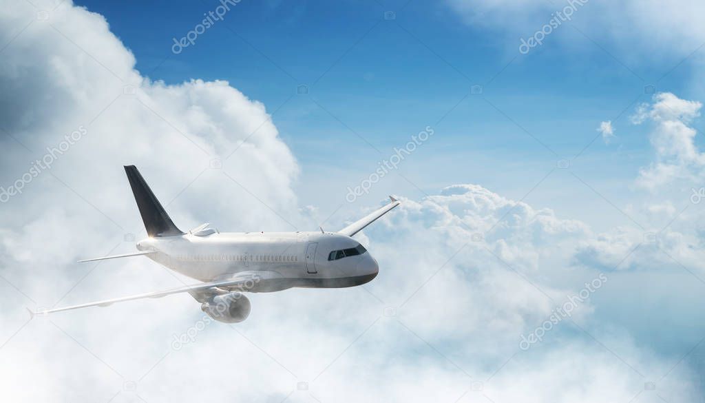 Commercial airplane jetliner flying above dramatic clouds.