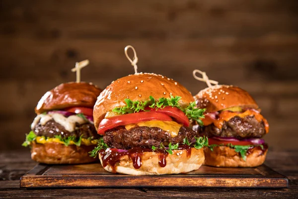 Sabrosas hamburguesas sobre mesa de madera. —  Fotos de Stock