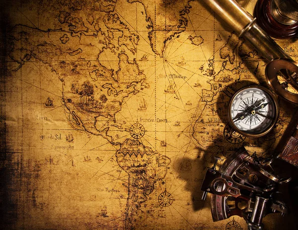 Old vintage navigation equipment on old world map. — Stock Photo, Image