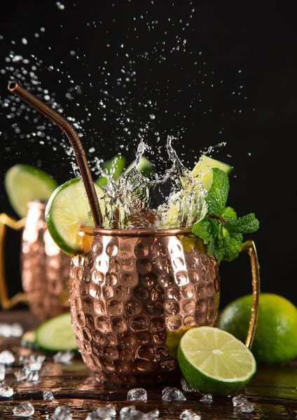 Famous splashing Moscow mule alcoholic cocktail in copper mugs.