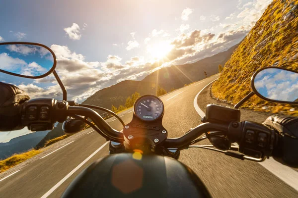 Motorcycle driver riding in Alpine highway, handlebars view, Austria, Europe. — Stock Photo, Image