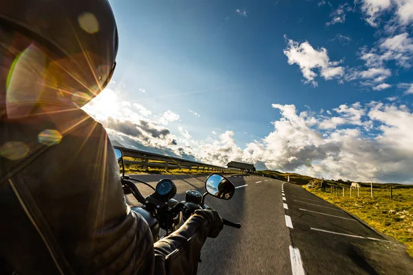 Motorcycle driver riding in Alpine highway, handlebars view, Austria, Europe. — Stock Photo, Image