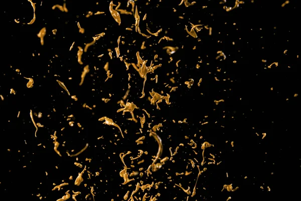 Abstract golden liquid splash on black background — Stock Photo, Image