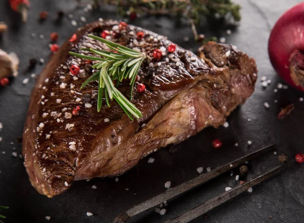 Gegrilde biefstuk op zwarte stenen tafel — Stockfoto
