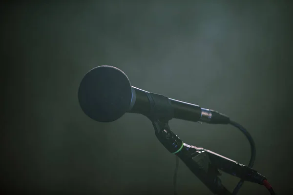 Metal microphone in holder on dark background — Stock Fotó