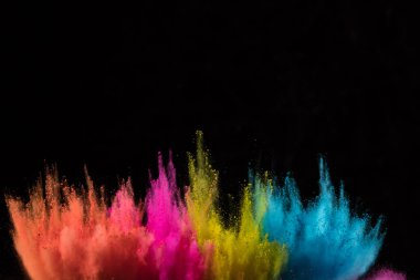 Colored powder explosion on black background. clipart