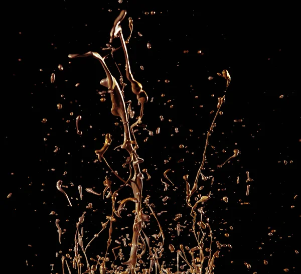 Abstract golden liquid splash on black background — Stock Photo, Image