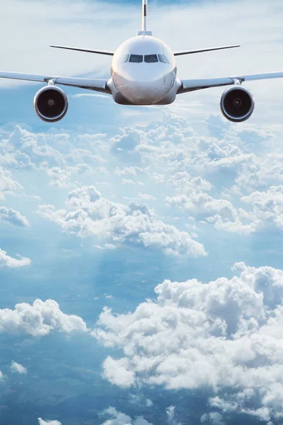 Commercial airplane jetliner flying above dramatic clouds. — Stock Photo, Image