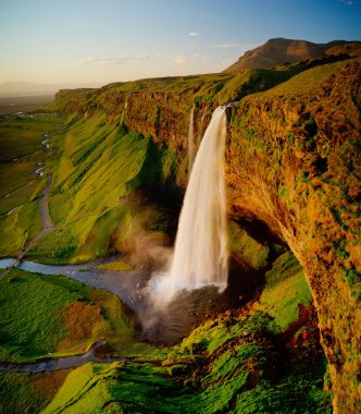 Beautiful Seljalandsfoss waterfall in Iceland during Sunset. clipart