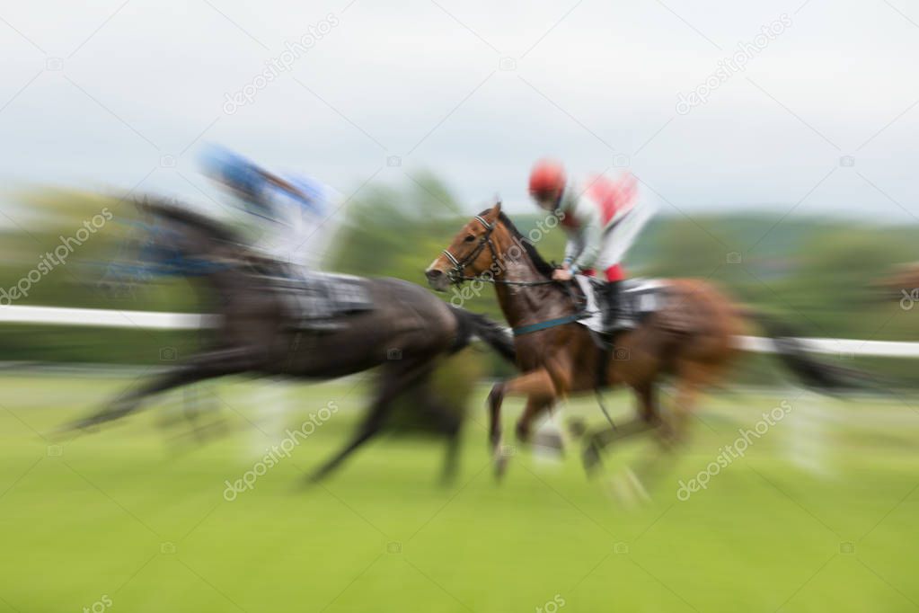 Race horses with jockeys on the home straight