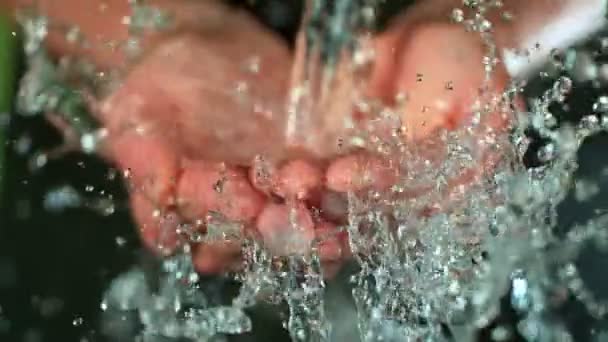 新鮮な水が女性の手に飛び散る、ゆっくりとした動き. — ストック動画