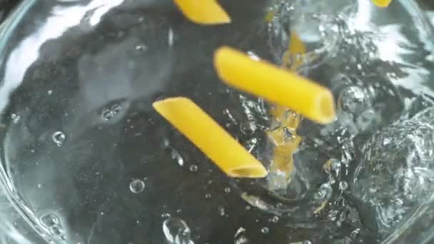 Throwing pasta into boiled water, slow motion. — Stock Video