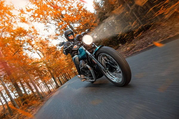 Motorradfahrerin fährt im Herbstwald — Stockfoto