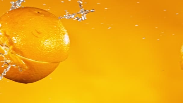 Super-Zeitlupe Schuss frischer Orangen Kollision mit Spritzwasser — Stockvideo