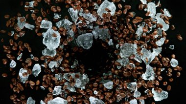 Taze kavrulmuş kahve çekirdekleri havada uçuşuyor.