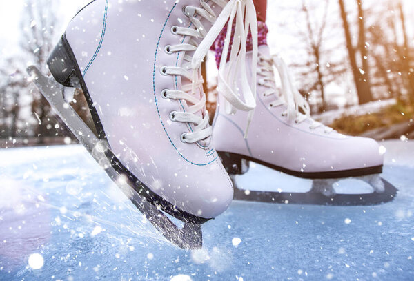 Close-up of woman ice skating on a pond.