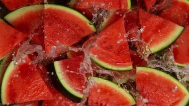 Super Slow Motion Shot of Fresh Pieces of Watermelons Falling into Water at 1000 fps