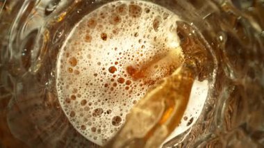 Super Slow Motion of Pouring Beer into Pint Glass, Top Down View, Camera Move. Filmed on High Speed Cinema Camera, 1000 fps.