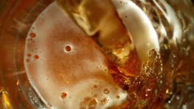 Super Slow Motion of Pouring Beer into Pint Glass, Top Down View, Camera Move. Filmed on High Speed Cinema Camera, 1000 fps.