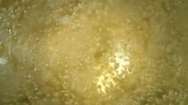 Super slow motion of champagne bubbles. Unique angle with underwater macro lens. Concept of celebration and success. Filmed on high speed cinema camera, 1000 fps