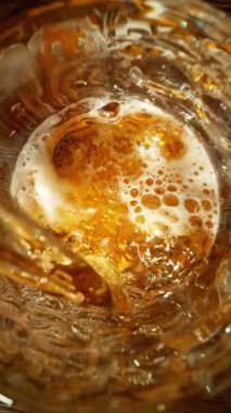 Super Slow Motion of Pouring Beer into Pint Glass, Top Down View. Filmed on High Speed Cinema Camera, 1000 fps.