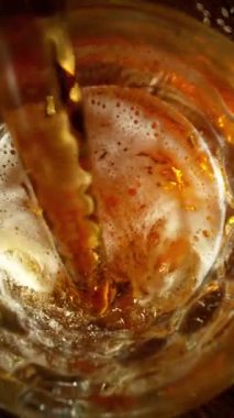 Super Slow Motion of Pouring Beer into Pint Glass, Top Down View. Filmed on High Speed Cinema Camera, 1000 fps.