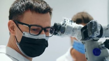 Modern Dental ofiste diş mikroskobu kullanarak asistan dişçi