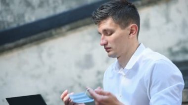 İş adamı yüzüne maske takıyor. COVID 'e karşı koruma - 19 Virüs Kavramı. Yavaş Hareket Efekti