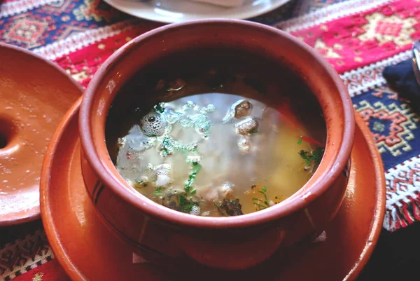 Soup khashlama. Traditional hot soup with lamb in a clay pot