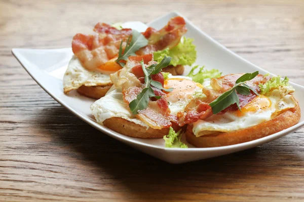 Bruschetta Con Rúcula Tocino Navideño Huevo Escalfado Servido Plato Blanco — Foto de Stock