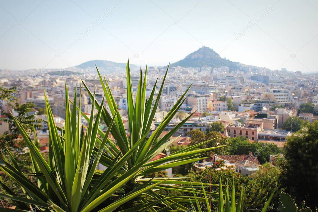 View over the city and the Lycabettus hill from Acropolis in Athens, Greece. Panorama of Athens . Beautiful cityscape with seashore .