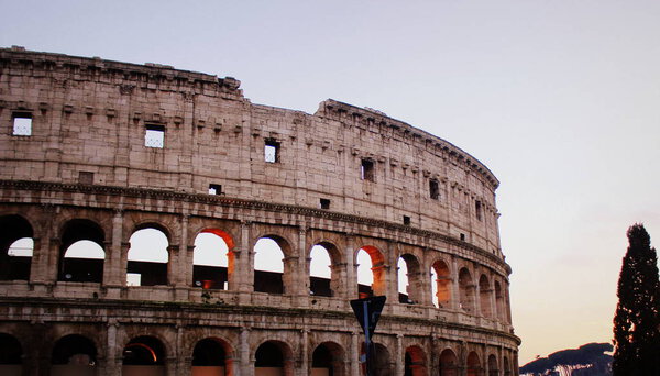 The iconic ancient Colosseum of Rome. View in sunrise .