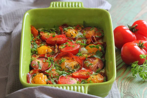 Cazuela con huevo, tomate y tocino sobre la mesa . — Foto de Stock