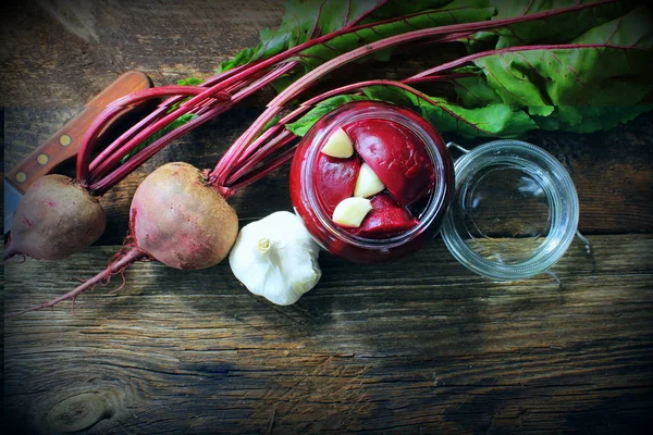 Pickled beets in the jar on a dark wood background — Stock Image Pickled beets in the jar on a dark wood background Royalty Free Stock Images