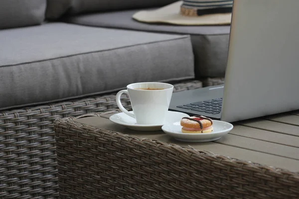 Outdoor furniture lounge group with chairs, sofa and table in a patio. Seating on the balcony, is a recreation place