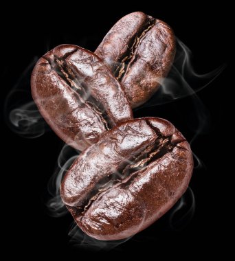 Three roasted coffee beans on the black background. clipart