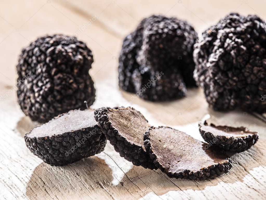 Black truffles on the old wooden table.