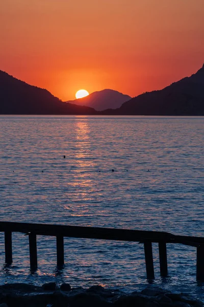 Vacker Solnedgång Havet Kusten Solen Inställningen Bakom Stenen Och Lämnar — Stockfoto