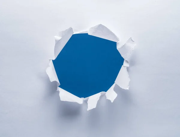 Hole on a paper. Blue background in the hole.