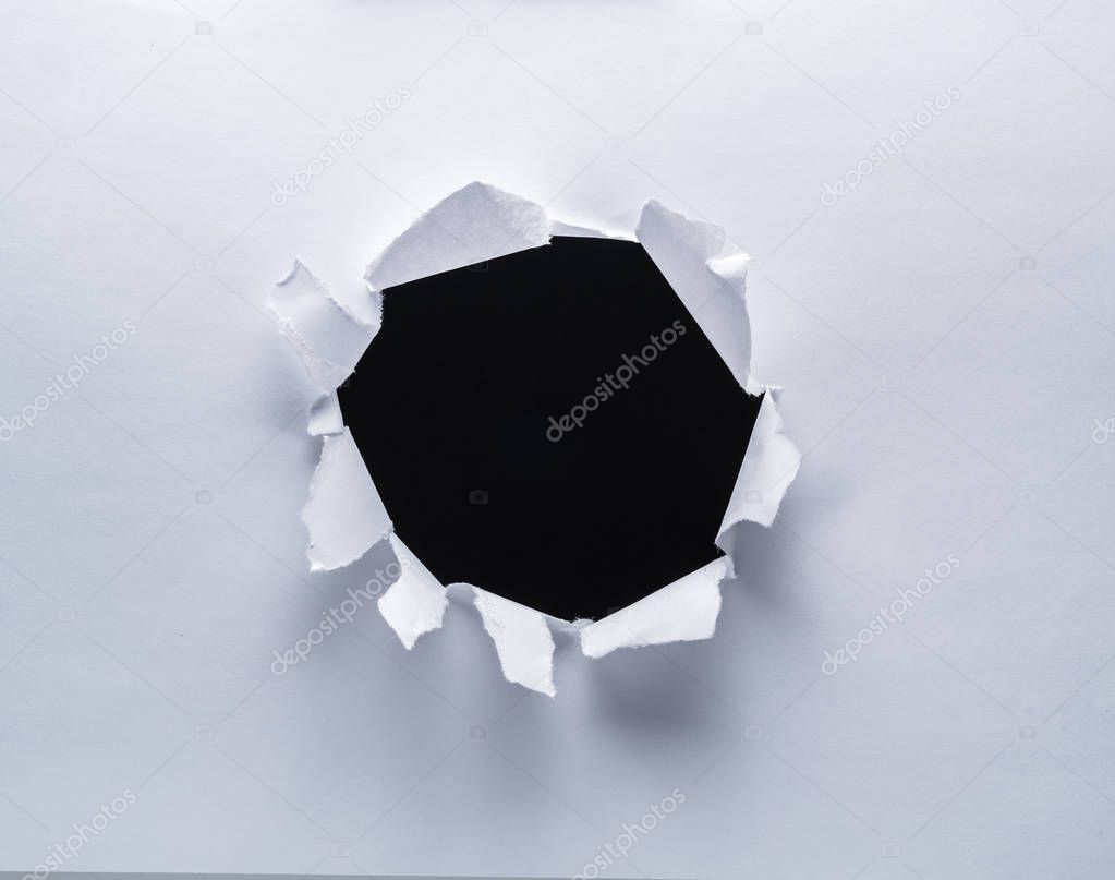 Hole on a paper. Black background in the hole.