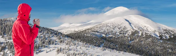 Winter hiking. Tourists are hiking in the snow-covered mountains. Beautiful winter landscape in the mountains.