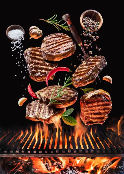 Grilled Beef Steaks Vegetables Spices Fly Blazing Grill Barbecue Fire — Stock Photo, Image