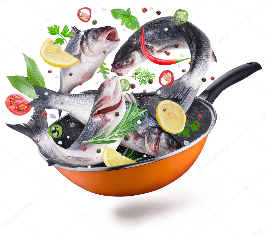 Flying seabass fishes and spices falling into a frying pan. Flying motion effect of cooking process. File contains clipping path.