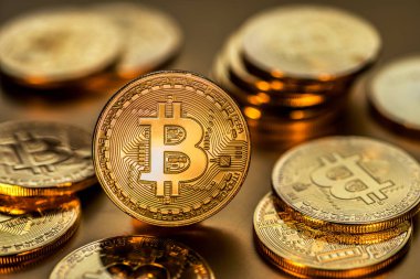 Altın arka plan üzerinde parlak fiziksel bitcoins. Blockchain teknoloji.