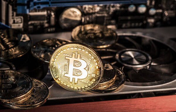 Shiny physical bitcoins and record-keeping equipment. Mining farm.
